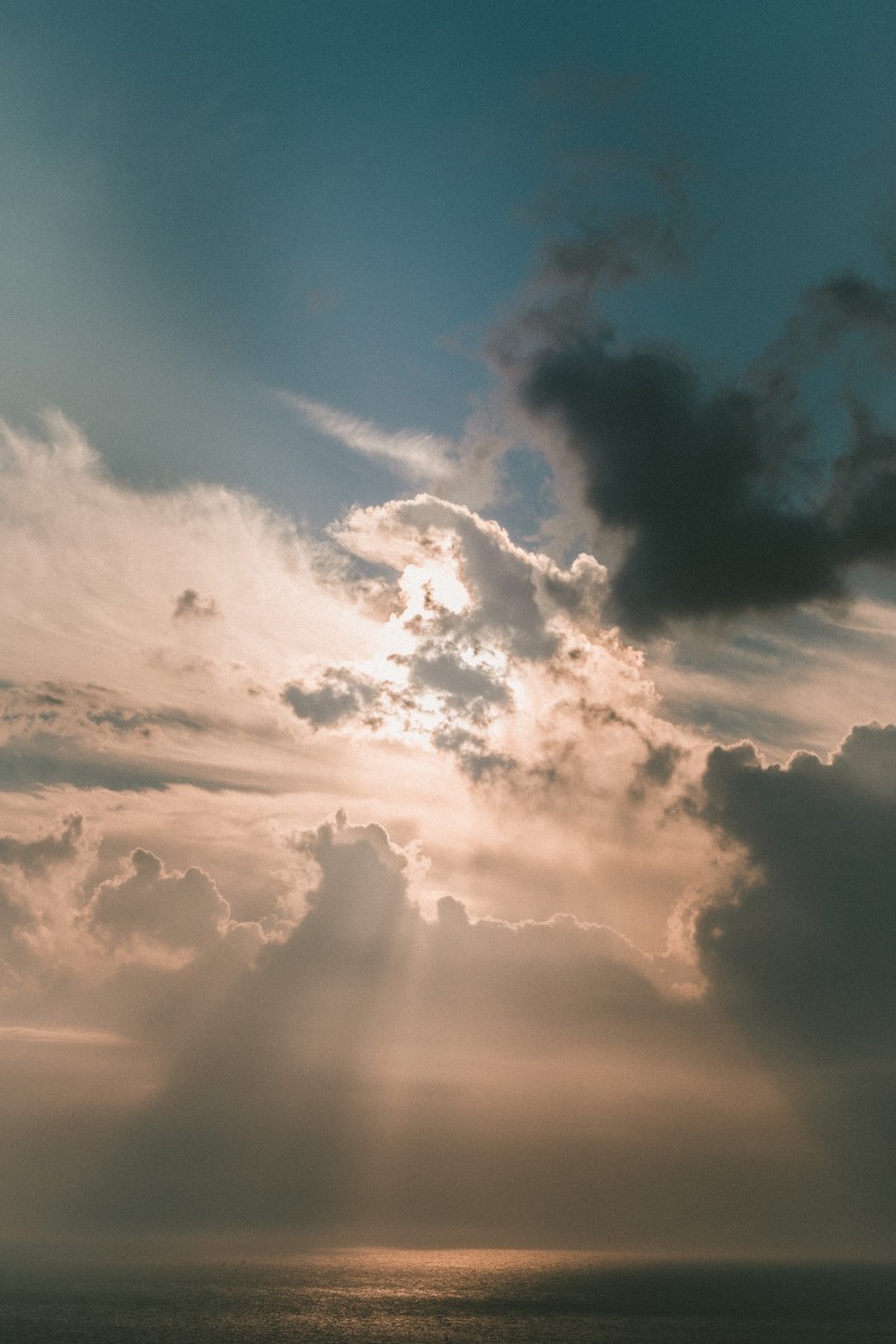 穿過雲層的陽光風景圖片