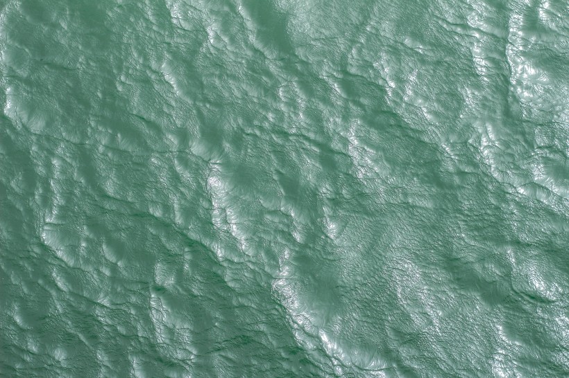 泛着波紋的平靜海面圖片